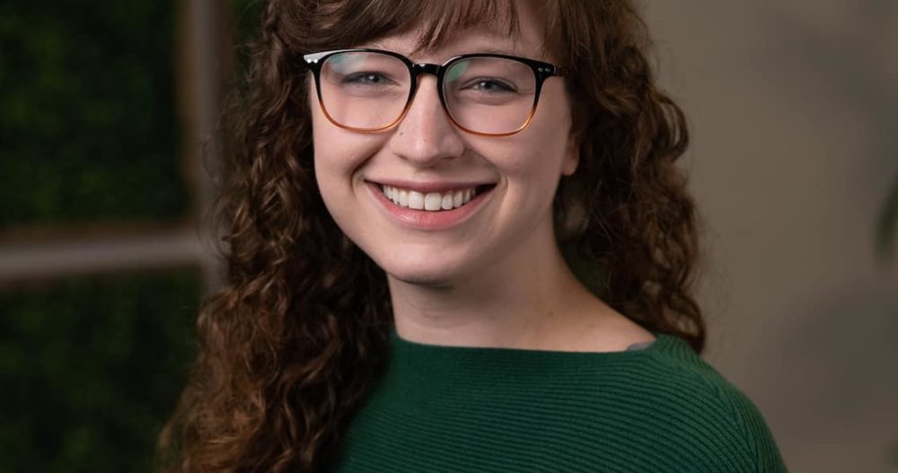 Headshot of April Knipfer, MSW, LICSW, dressed in a green top, wearing dark-rimmed eyeglasses.