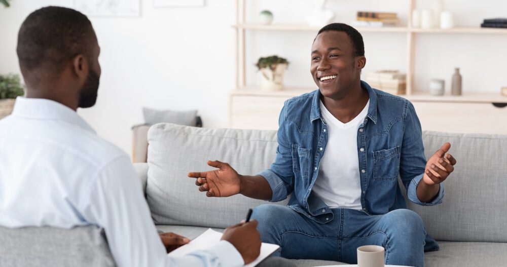 two men sitting and talking during psychedelic therapy