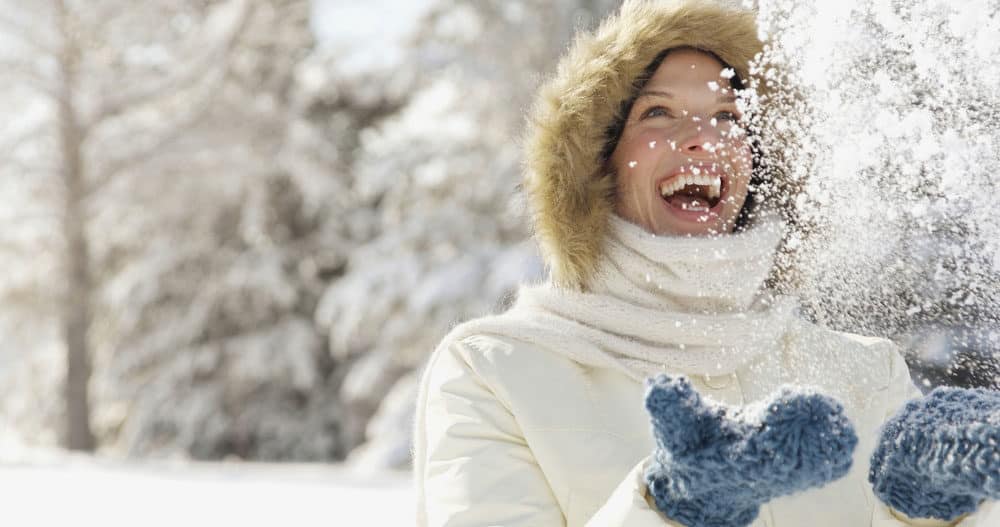 Woman plays in the snow