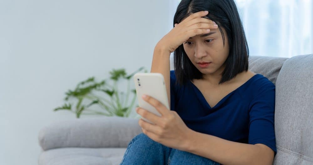 Stressed woman on the phone and in need of digital detoxing