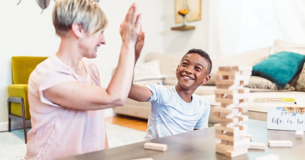 Woman High fiving a boy while playing Jenga