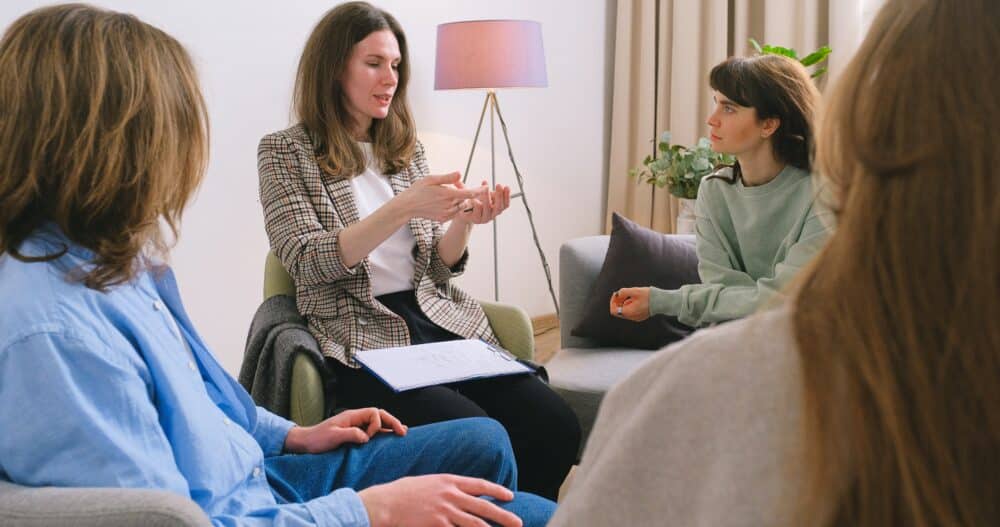 Women sitting in a circle doing group therapy