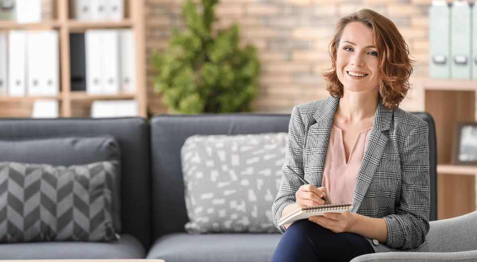 Woman sitting on a therapy couch smiling