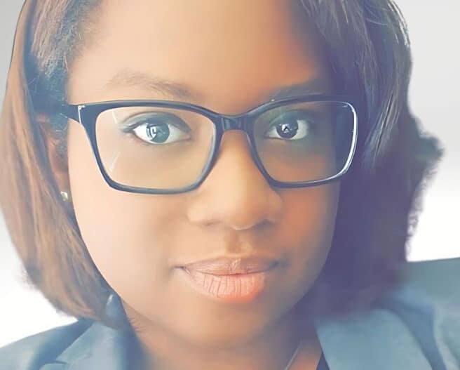 Headshot of Bria Haynes, PsyD, wearing dark rimmed glasses.