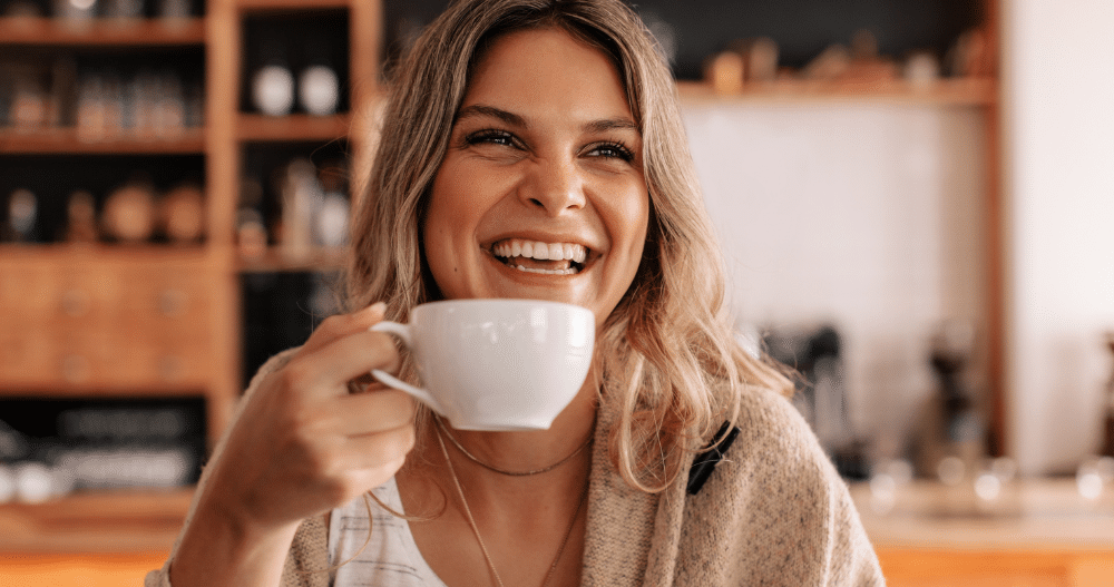 Portrait of a young woman sitting in a coffee shop drinking coffee