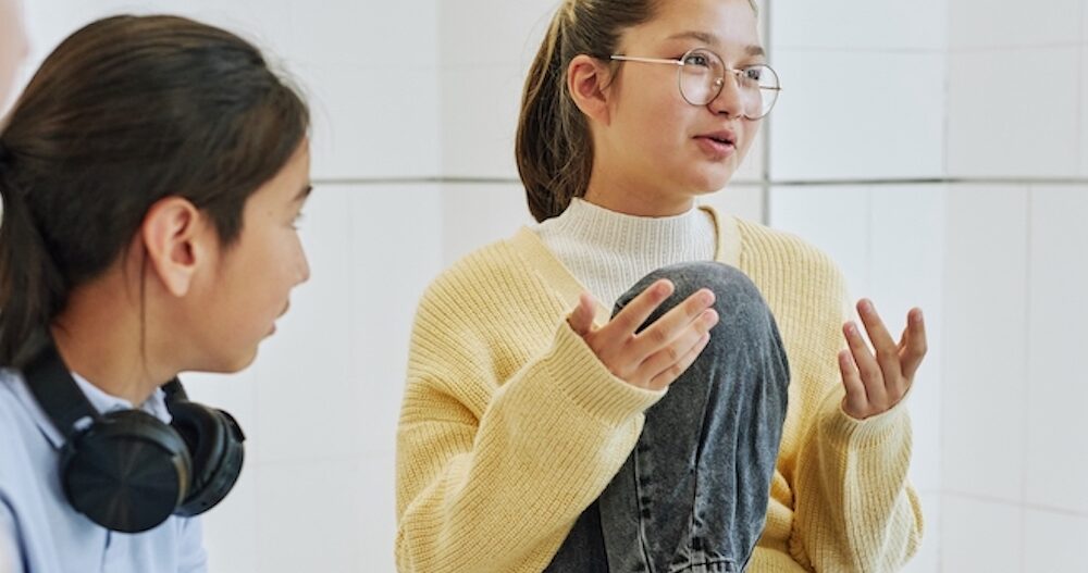 Portrait of teenage girl sharing feelings in support group circle for children