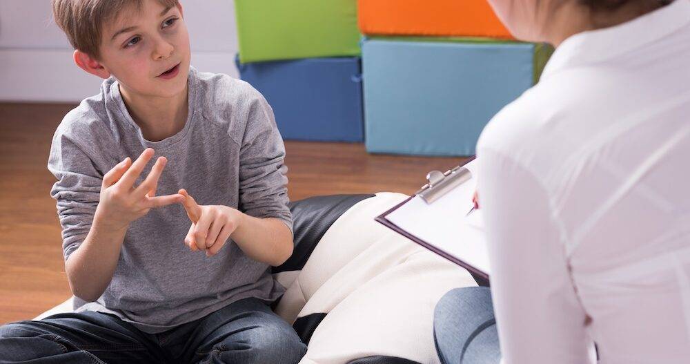 Shot of a little boy talking to a psychologist